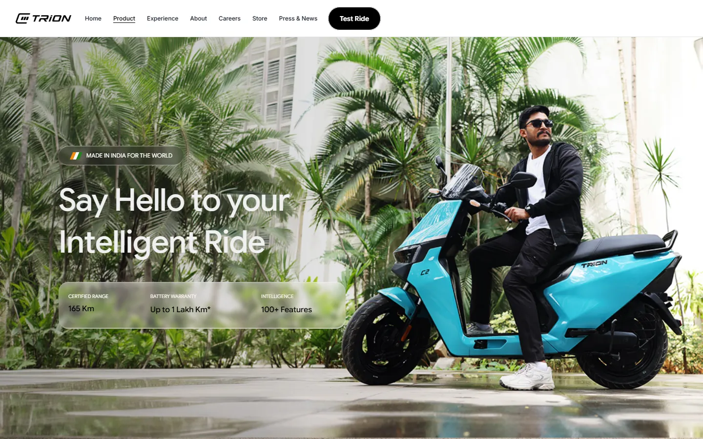The TRION product page: a rider on a blue E3 TRION scooter under palm trees